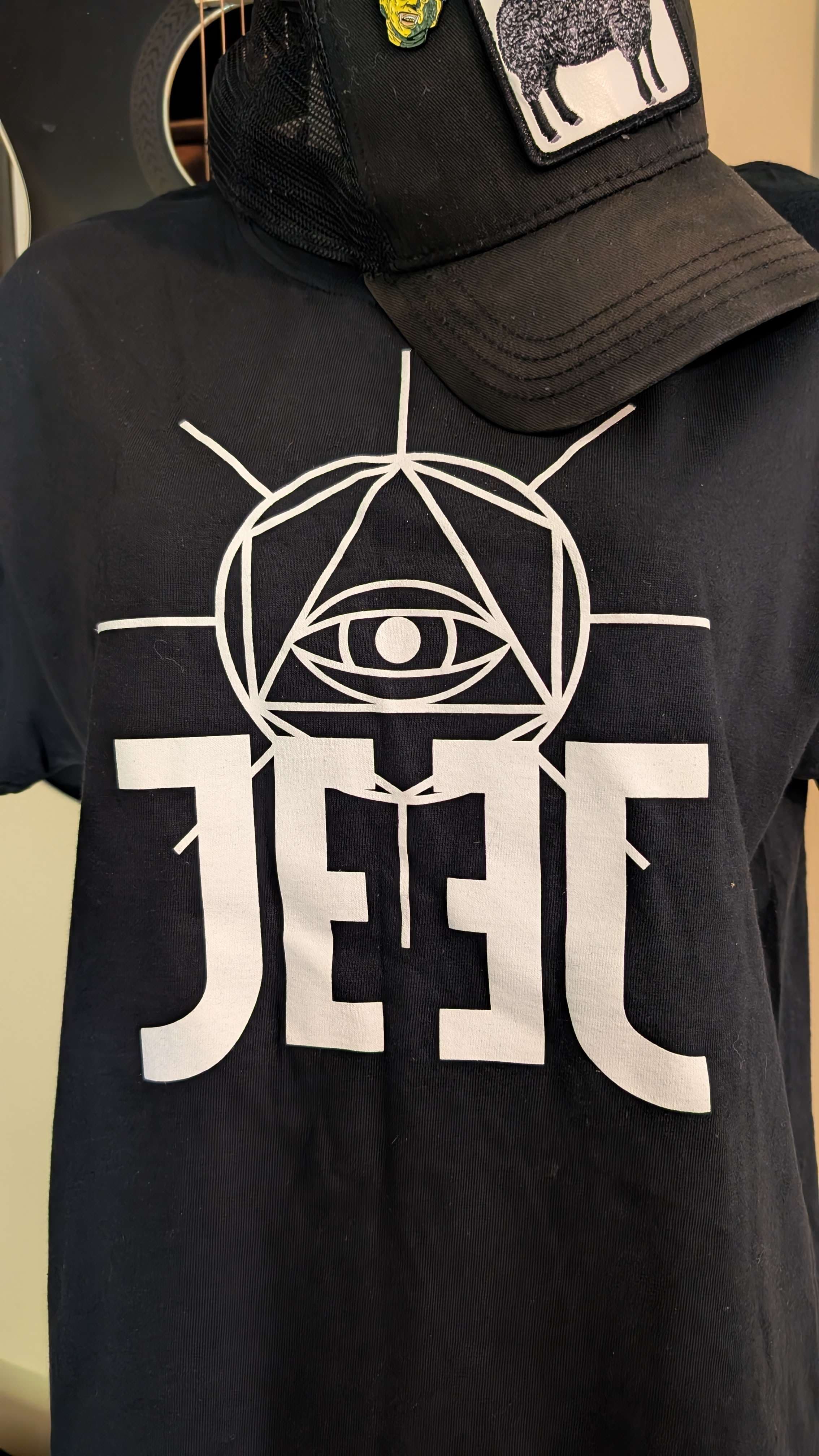 a black t - shirt with the word jeel on it